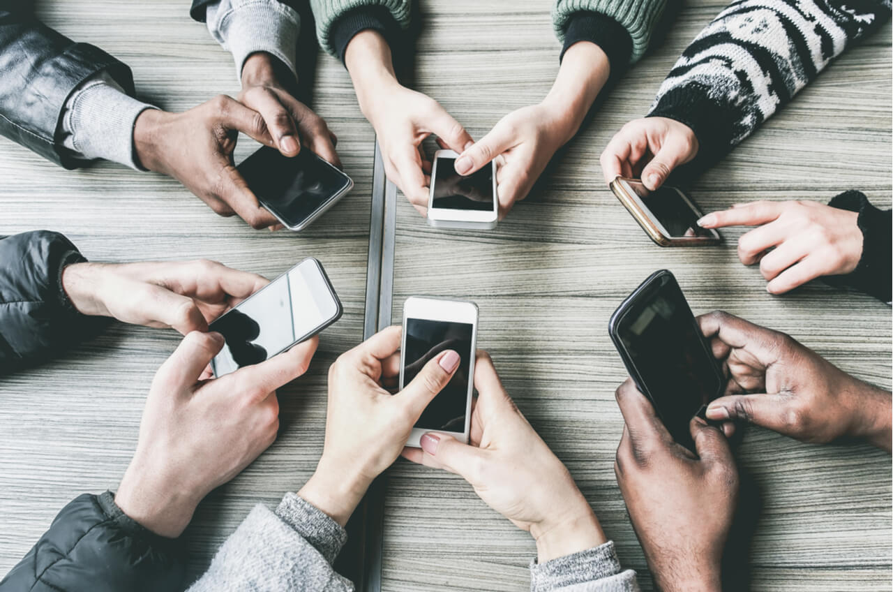 overhead view of hands using cell phones