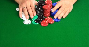 hands shoving poker chips all-in